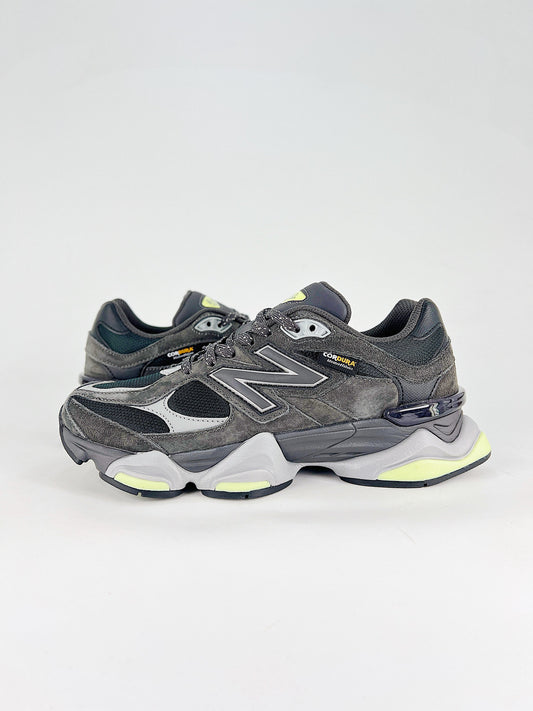 New Balance 9060 sneakers shown are in a black and cement colorway, often featuring a durable mesh and suede construction with Lime accents