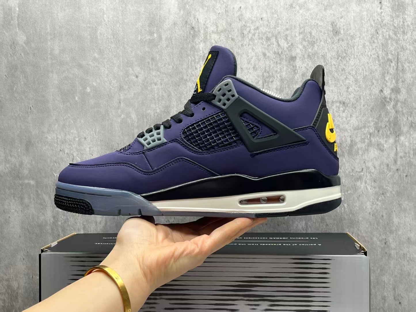 Air Jordan 4 Retro "Lakers" sneaker in an Imperial Purple nubuck upper with black and yellow accents