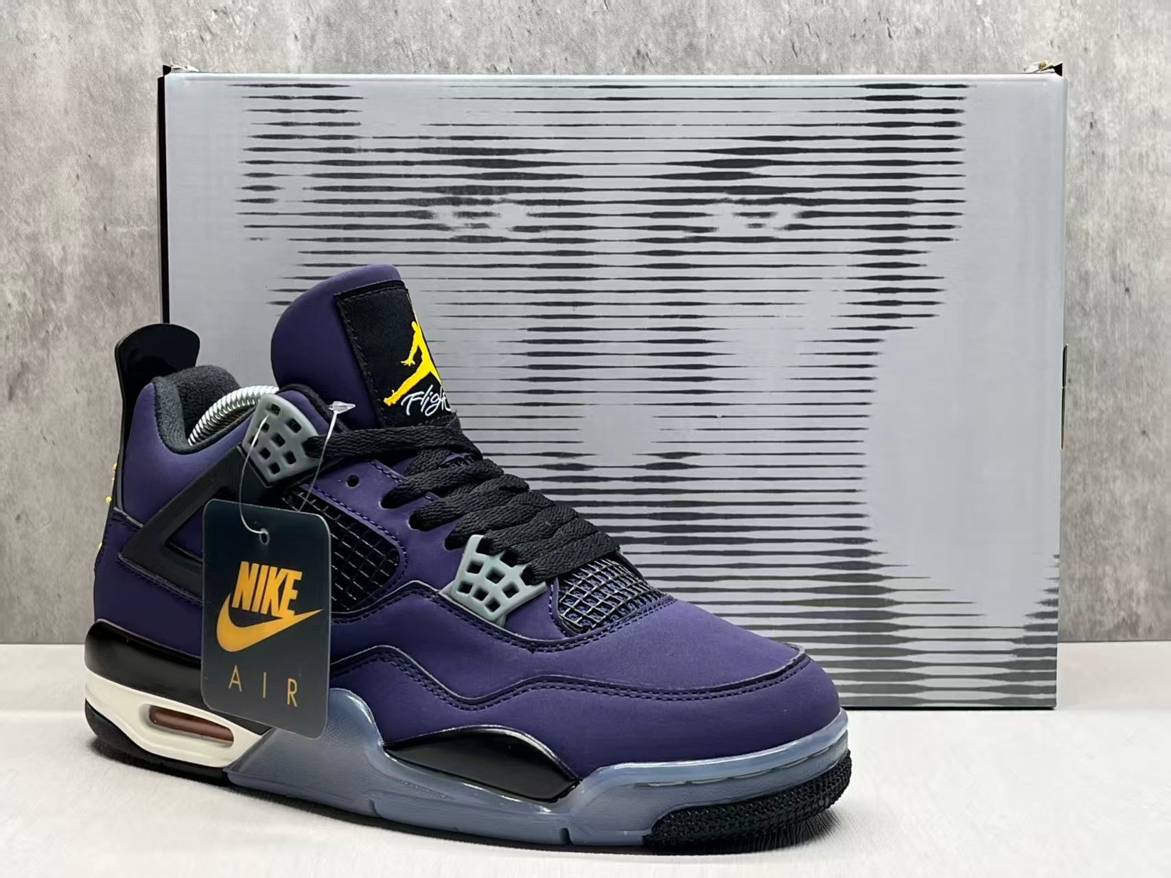 Air Jordan 4 Retro "Lakers" sneaker in an Imperial Purple nubuck upper with black and yellow accents