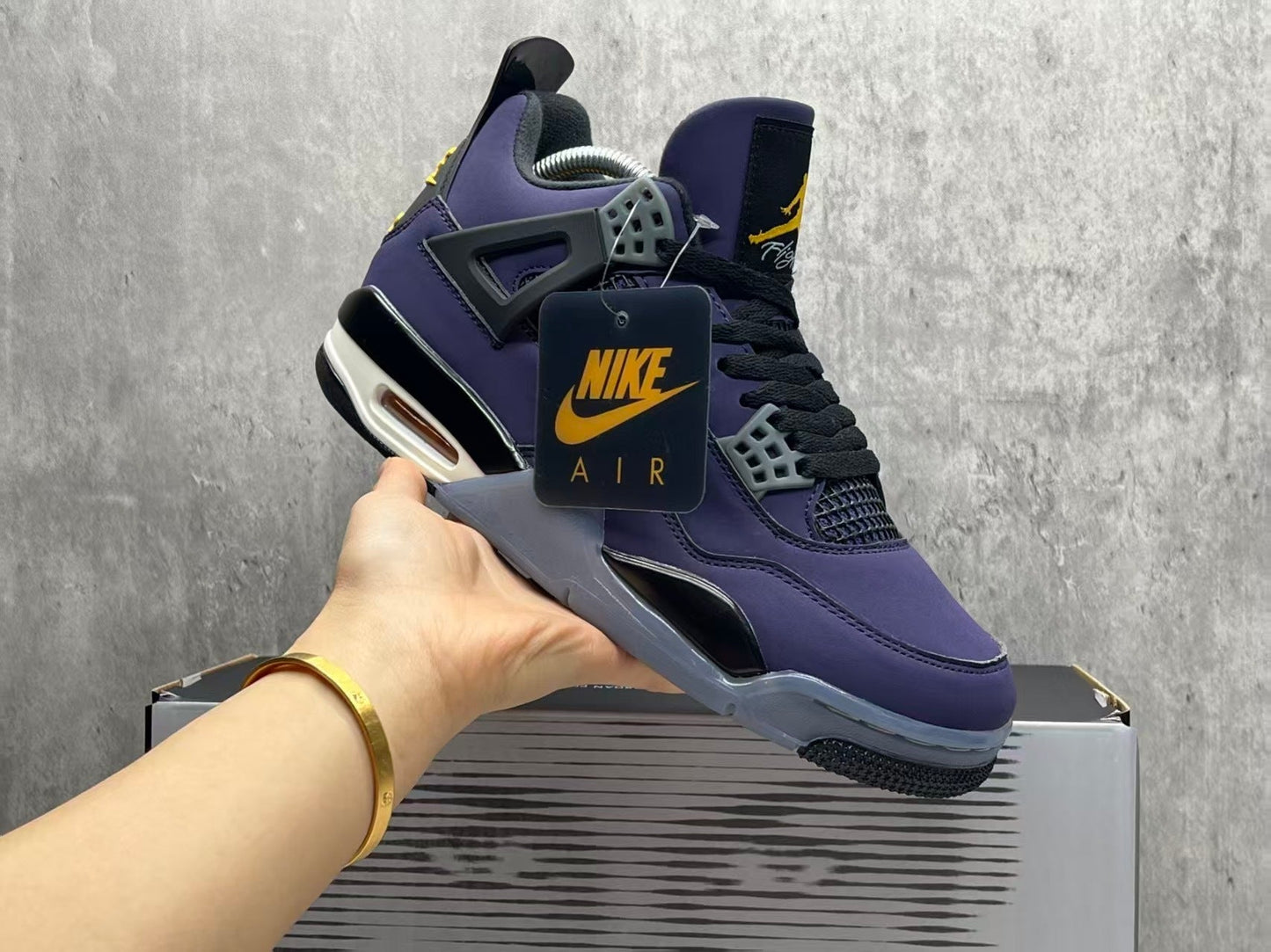 Air Jordan 4 Retro "Lakers" sneaker in an Imperial Purple nubuck upper with black and yellow accents