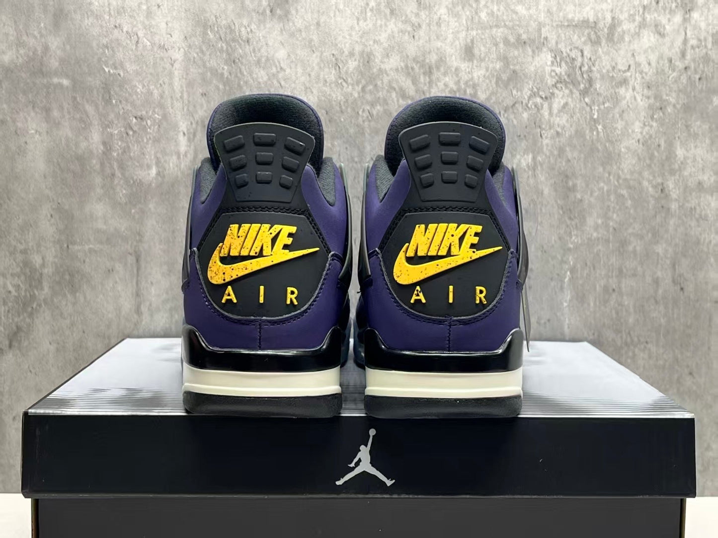 Air Jordan 4 Retro "Lakers" sneaker in an Imperial Purple nubuck upper with black and yellow accents