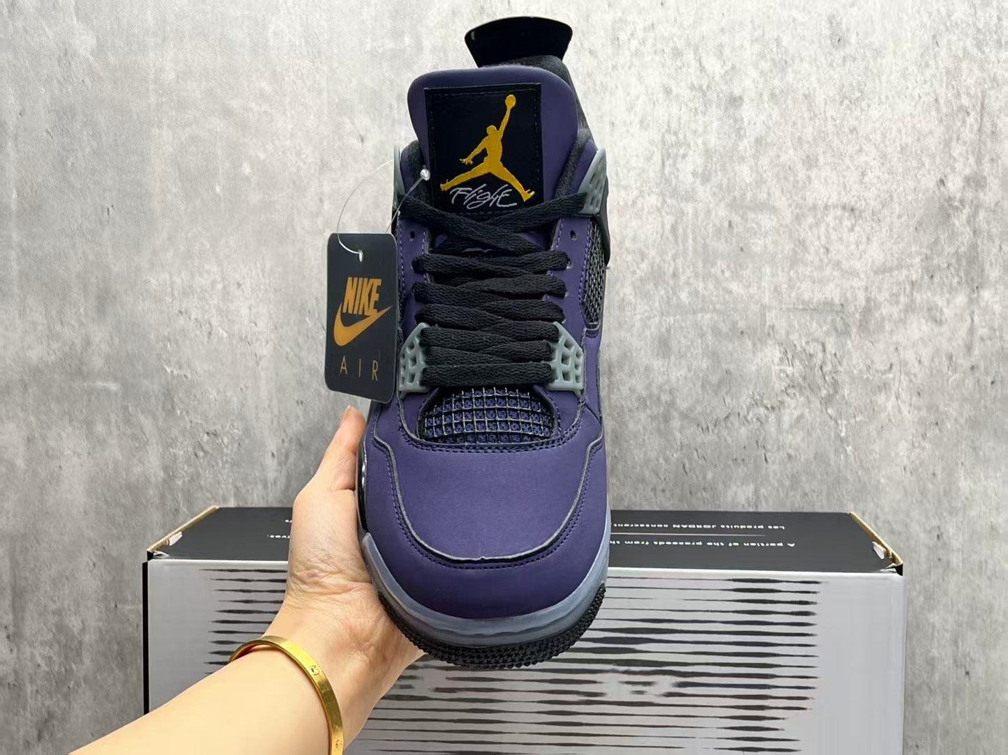 Air Jordan 4 Retro "Lakers" sneaker in an Imperial Purple nubuck upper with black and yellow accents