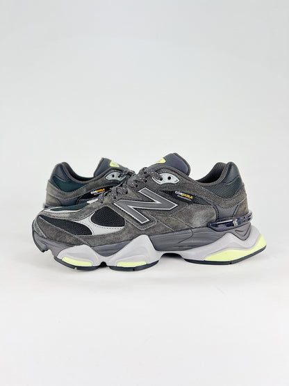New Balance 9060 sneakers shown are in a black and cement colorway, often featuring a durable mesh and suede construction with Lime accents